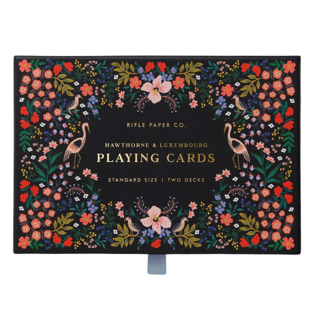 Playing cards in floral adorned box.