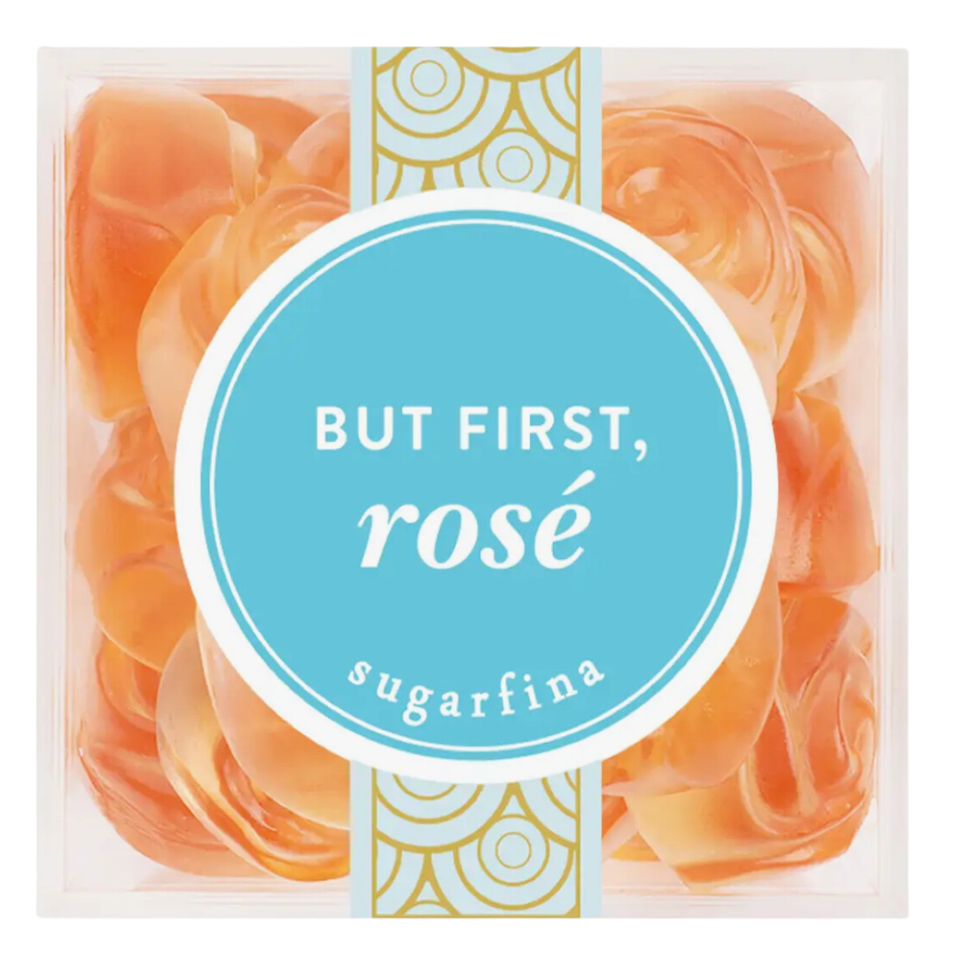 Sugarfina's But First Rosé gummy roses in a clear acrylic cube, a tasteful blend of elegance and indulgence.