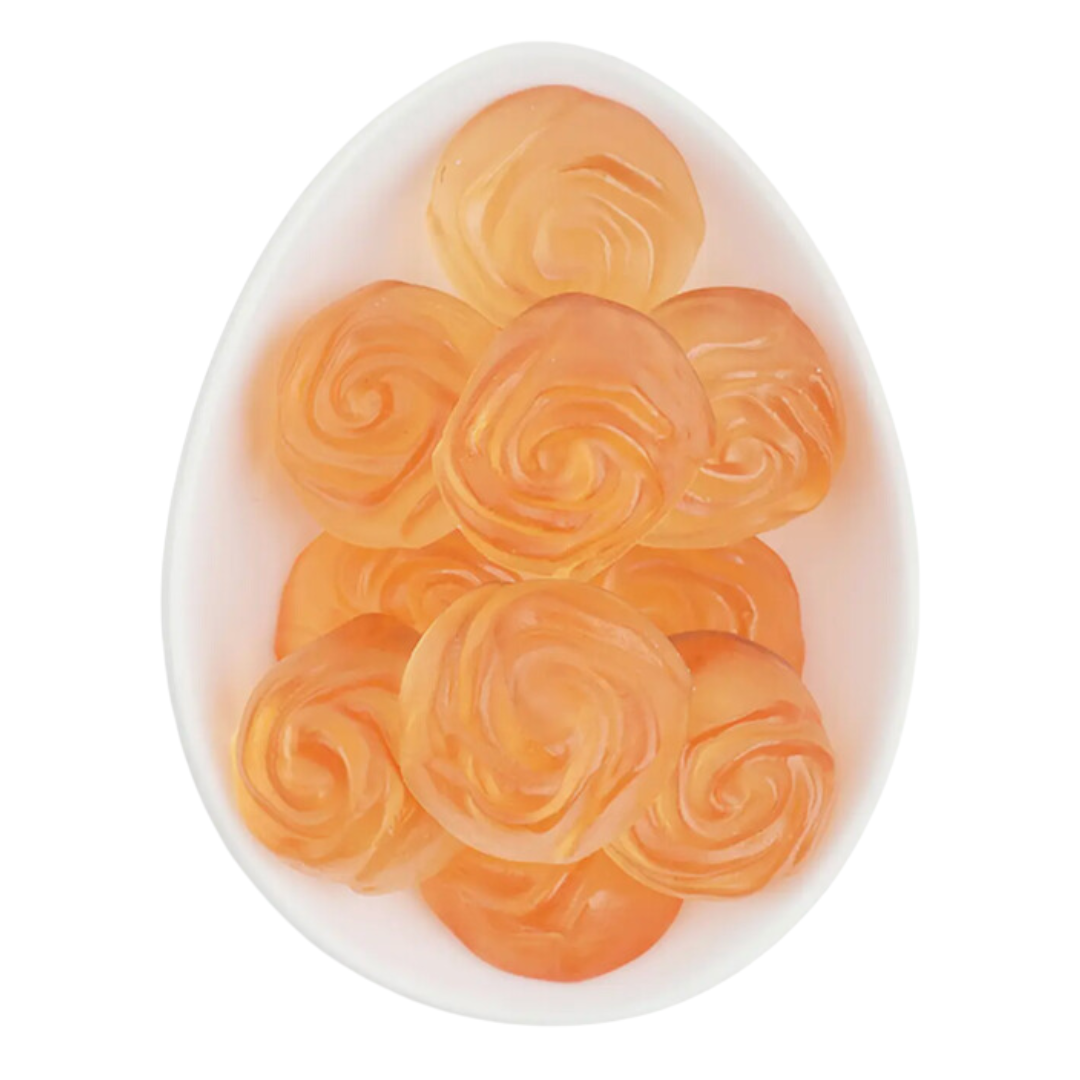 Chic display of Sugarfina's But First Rosé gummy roses, a tasteful treat encapsulated in a clear acrylic cube.