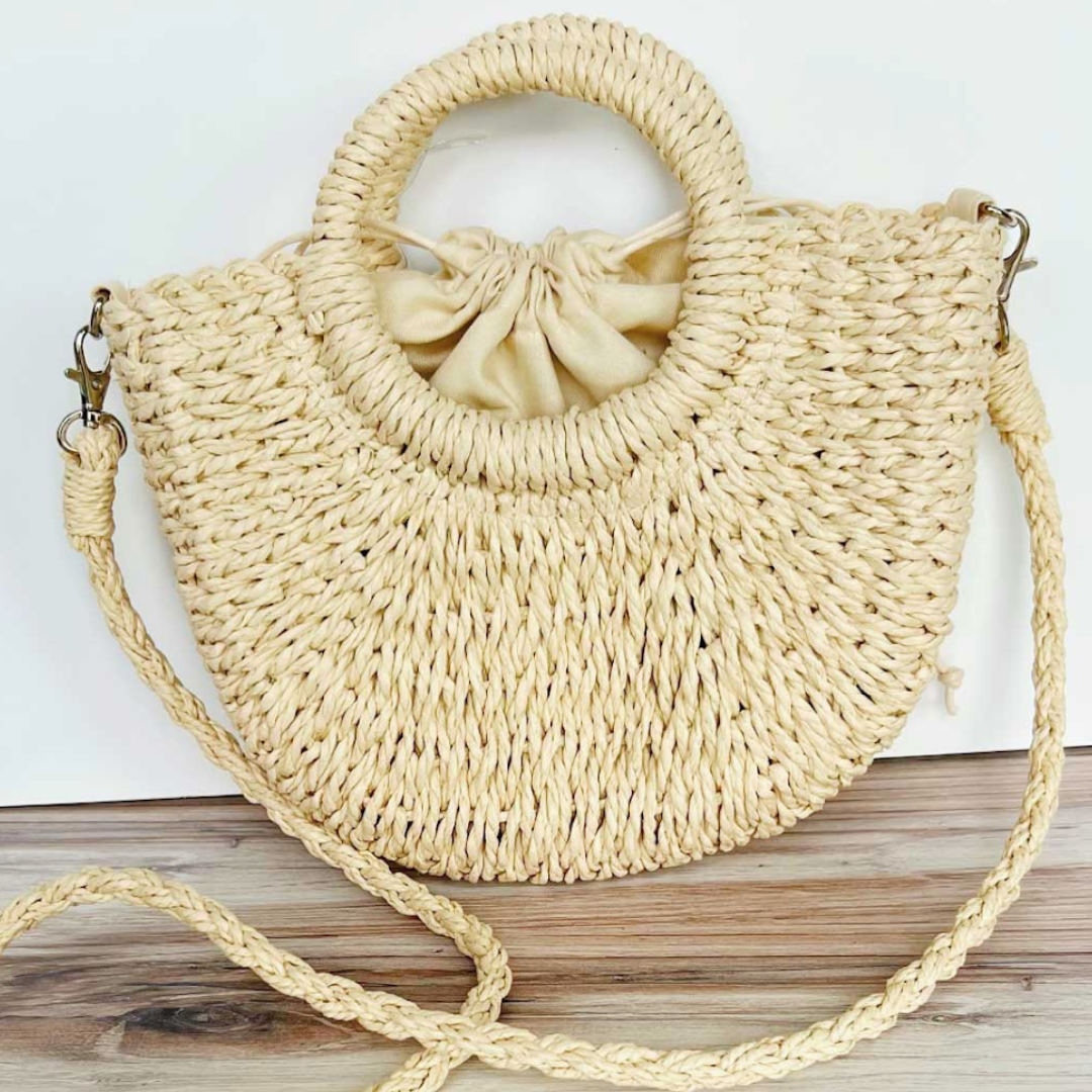Straw beach bag with handles and shoulder strap, perfect for sunny getaways.