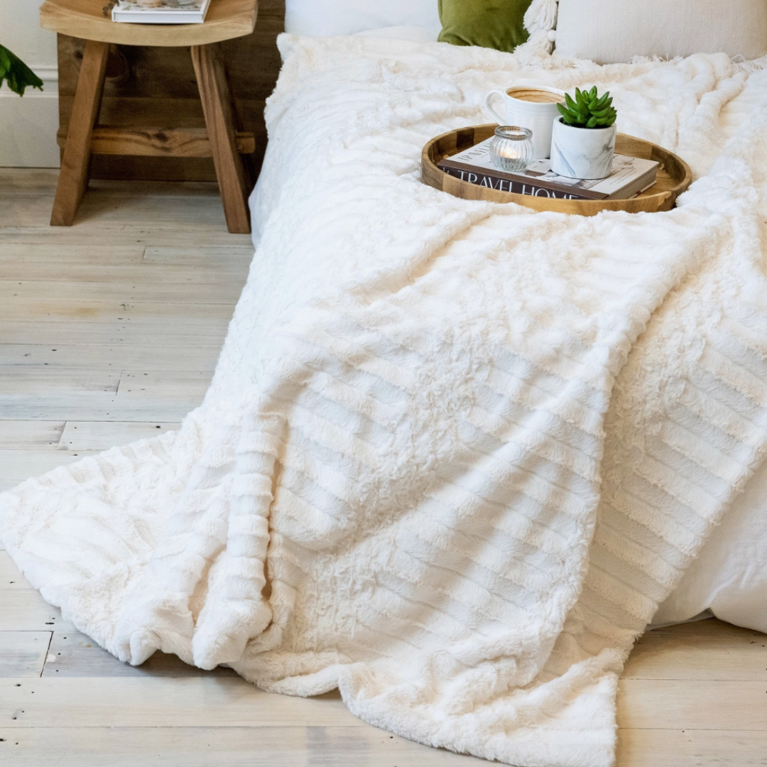Soft cream throw blanket, 55"x70", perfect for cozying up on chilly nights or adding warmth to any room decor.