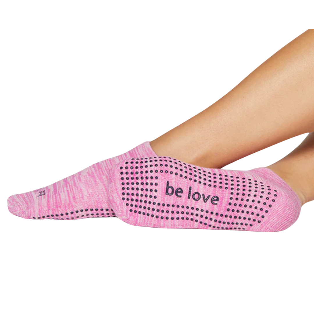     Vibrant pink grip sock by Sticky Be, empowering your workout with the uplifting message "Be Love" on the sole.