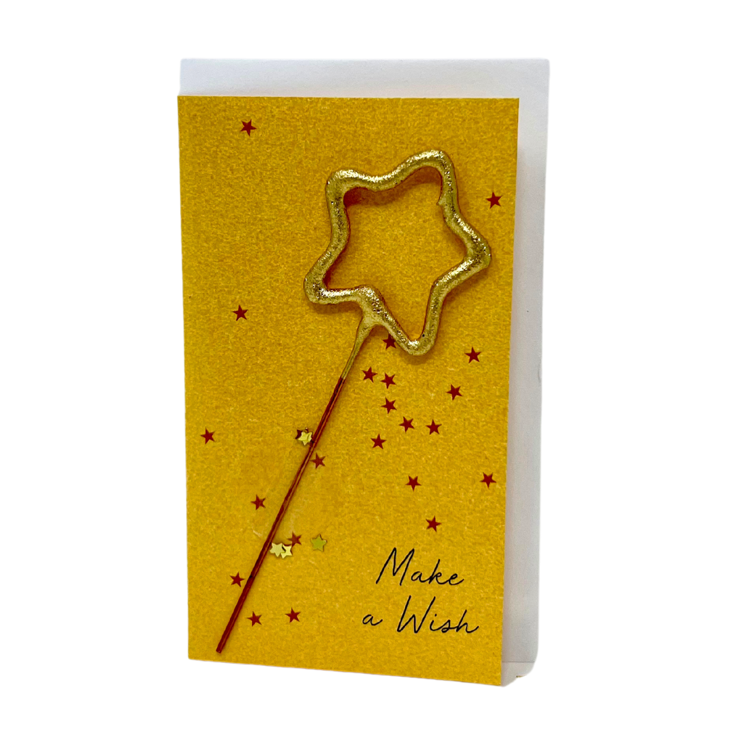 Gold star sparkler candle glowing on a cake, adding a festive touch to celebrations with its shimmering brilliance.