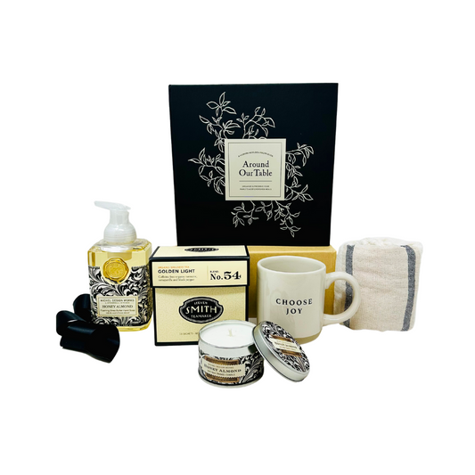 A beautifully arranged "Heart Of The Home" gift box from Me To You Box, featuring an assortment of curated items including candle, designer foam soap, four mugs, kitchen towel and recipe book all elegantly packaged in a stylish box.
