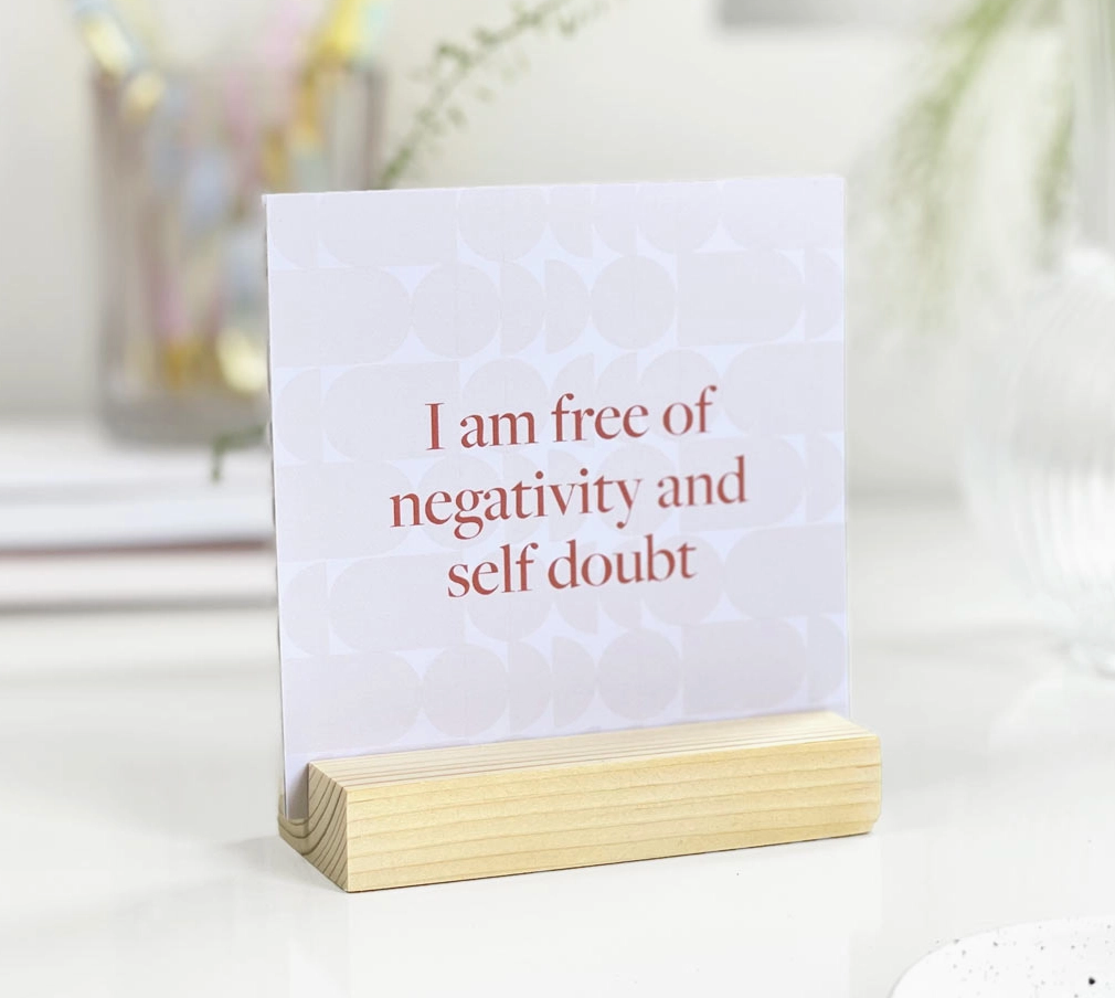 Wooden stand showcasing empowering affirmations to brighten your day.