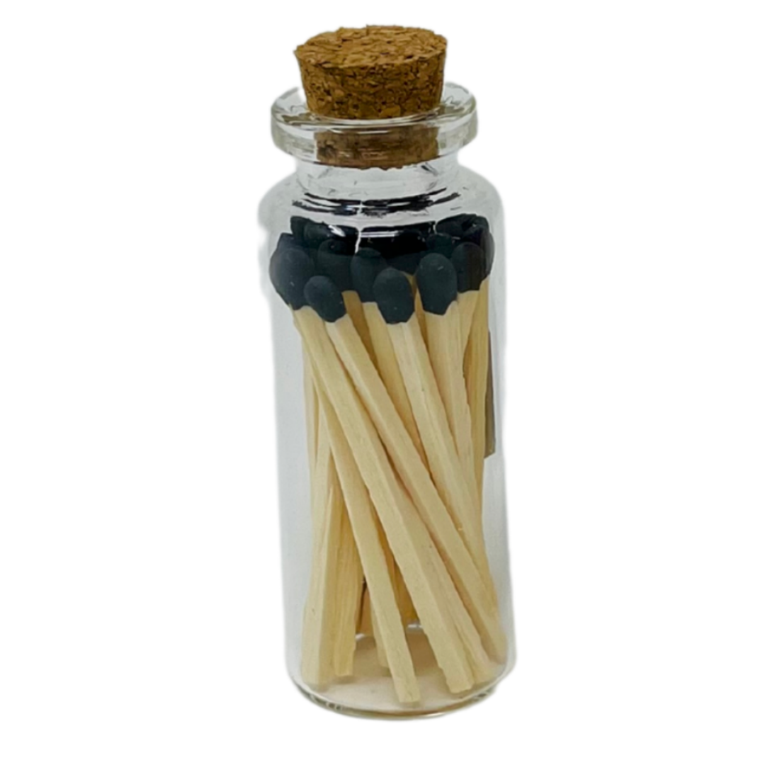 Glass jar with cork top holds 20 black-tipped two inch wooden matches, creating a stylish and functional fire-starting display.