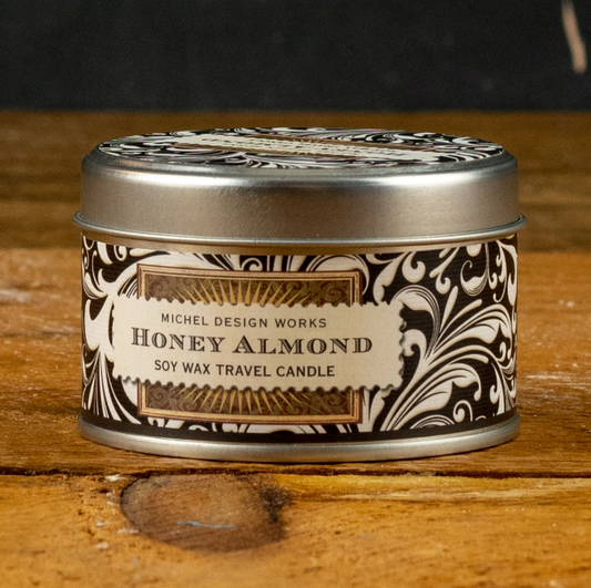 Michel Design Works soy wax travel candle. Create the perfect ambiance with this Honey Almond Soy Wax Tin Candle. Infused with the soothing essence of honey and almonds, it's a sensory treat. Customize your Me To You Box by including this aromatic gem for a truly curated gift experience.