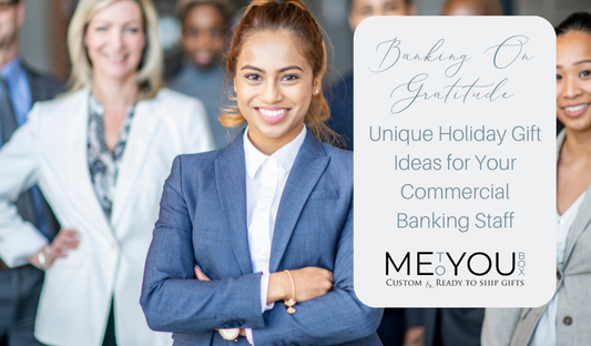 Several employees in business attire standing together smiling. This image is used at the top of a blog about unique holiday gifts for bankers.
