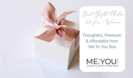 Satin bow wrapped around a small white gift box.