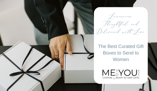 Black satin ribbon wrapped around 3 white gift boxes while a woman holds one.