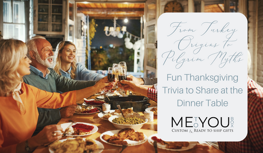 Several smiling people sitting around a Thanksgiving dinner table holding their wine glasses and toasting.
