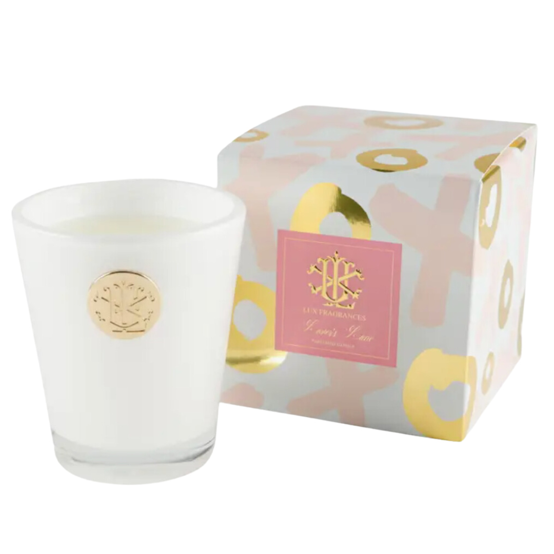 White glass candle adorned with gold XOXO Lovers Lane medallion, creating an elegant and romantic ambiance.