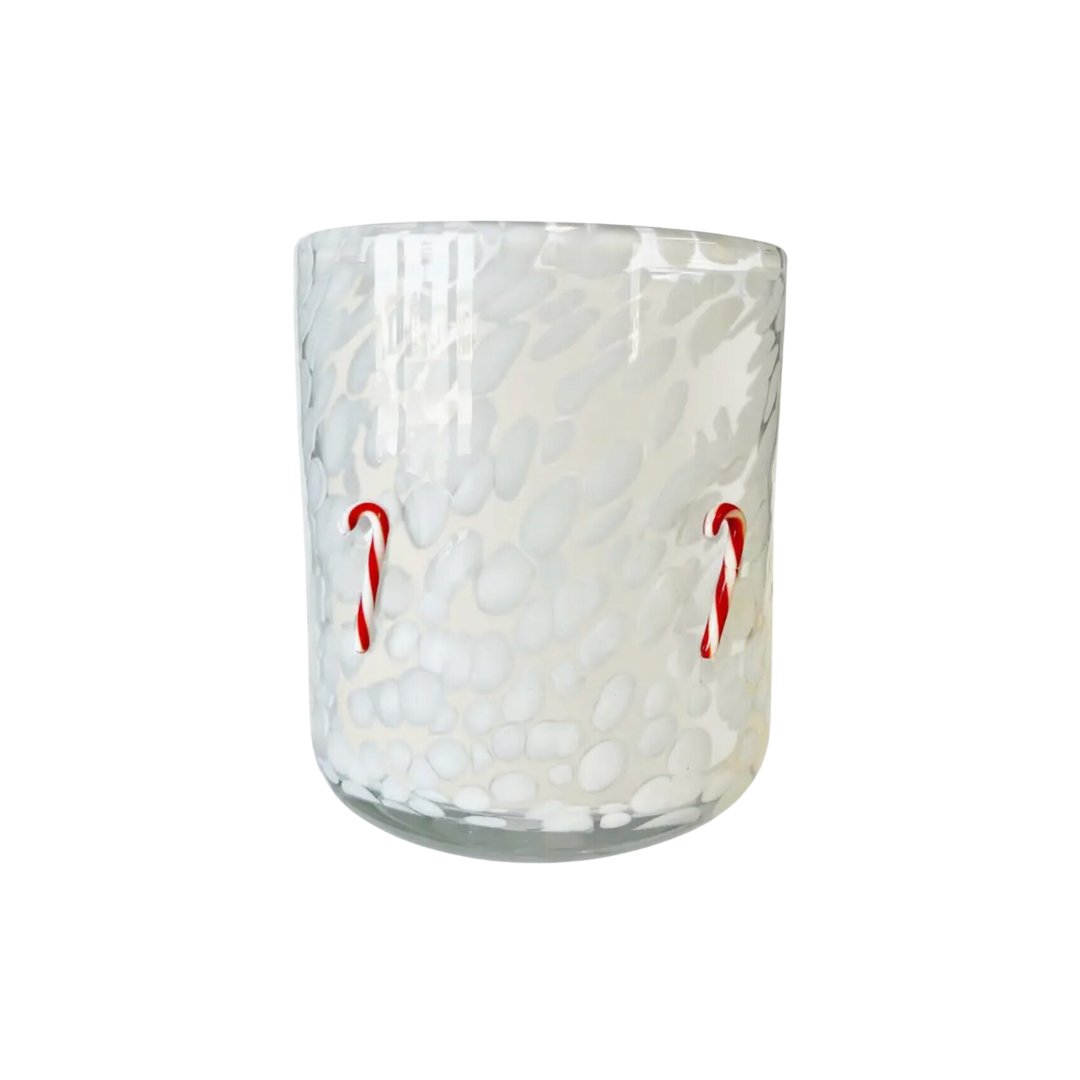 A 12oz white glass candle in a whimsical design, featuring candy canes. This vegan and cruelty-free candle makes a charming holiday gift, and the container can be repurposed for keepsakes or other decorative uses.