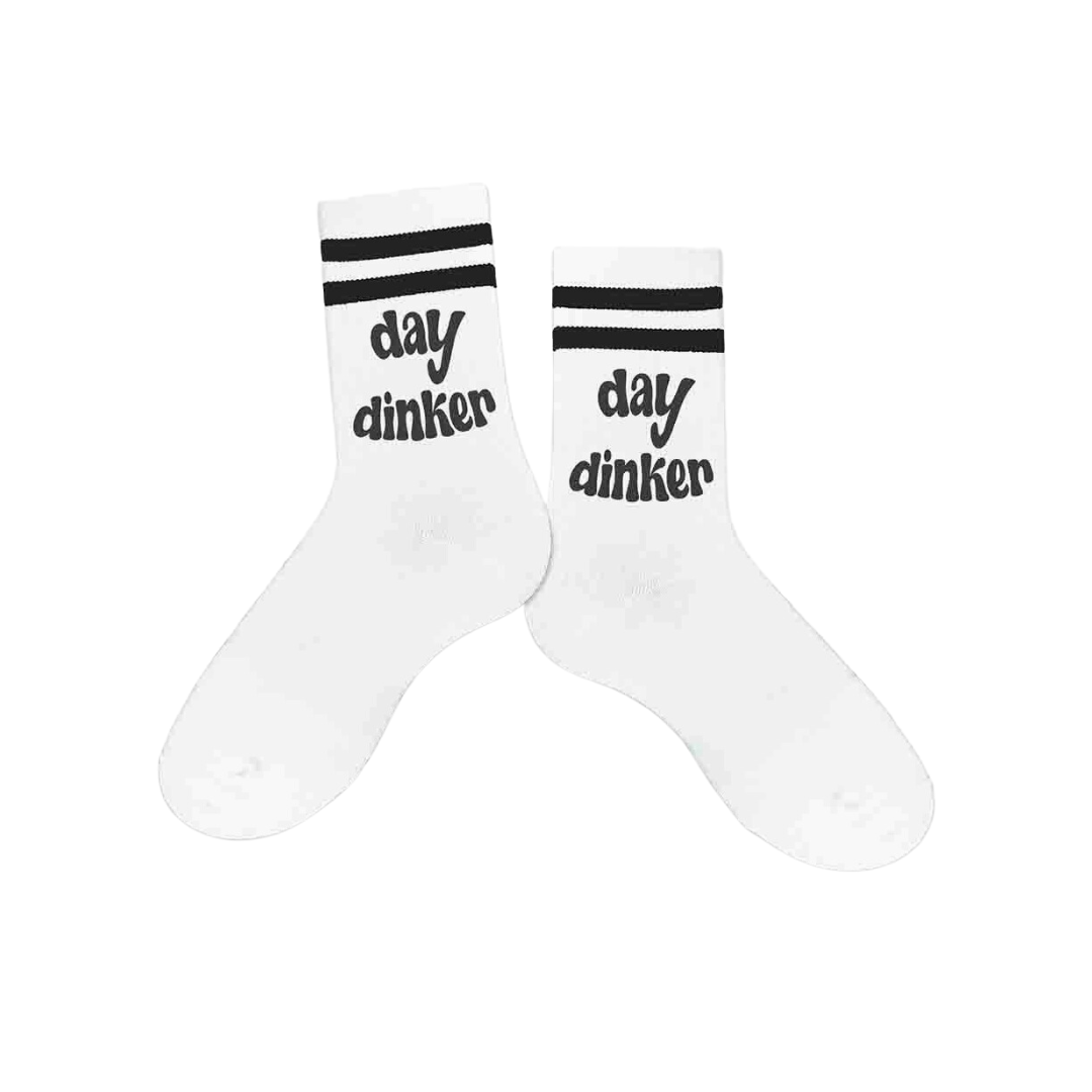 Women's crew pickleball socks featuring the text 'Day Dinker', adding a playful touch to pickleball attire.