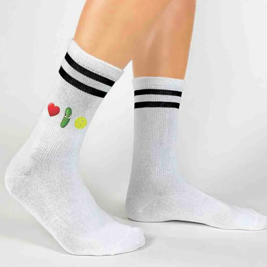 Women's crew pickleball socks adorned with heart, pickle, and pickleball motifs, symbolizing affection for the sport.