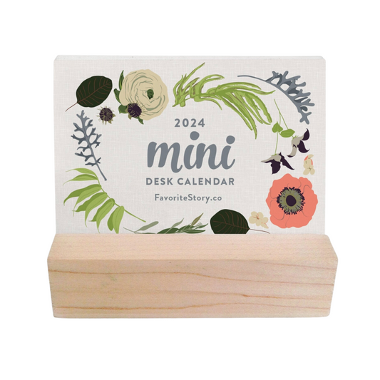 Floral mini desk calendar on wooden base, featuring vibrant blossoms for each month.