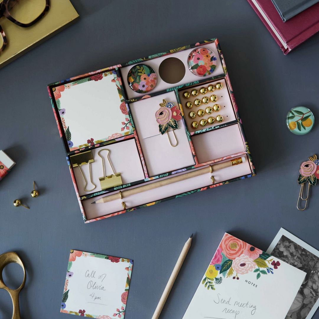 Desk organizer: Pink floral divided box holding office essentials, adding beauty to workspace.
