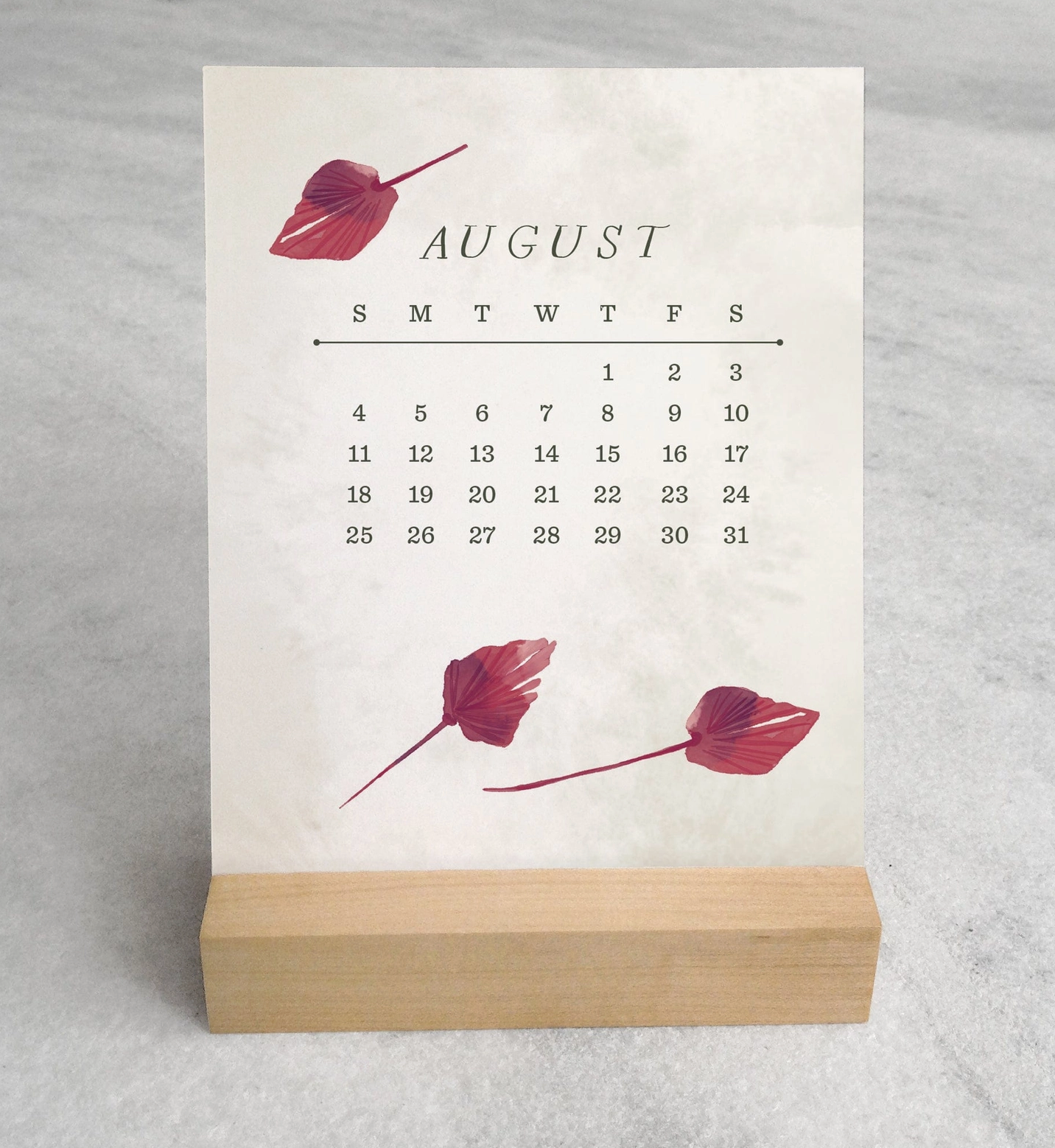 The 2025 Desk Calendar from Me To You Box, featuring 4.25" x 5.5" cards with unique monthly designs and a durable maple wood stand. This compact calendar fits perfectly on any desk, offering daily inspiration and organization with a touch of aesthetic charm.