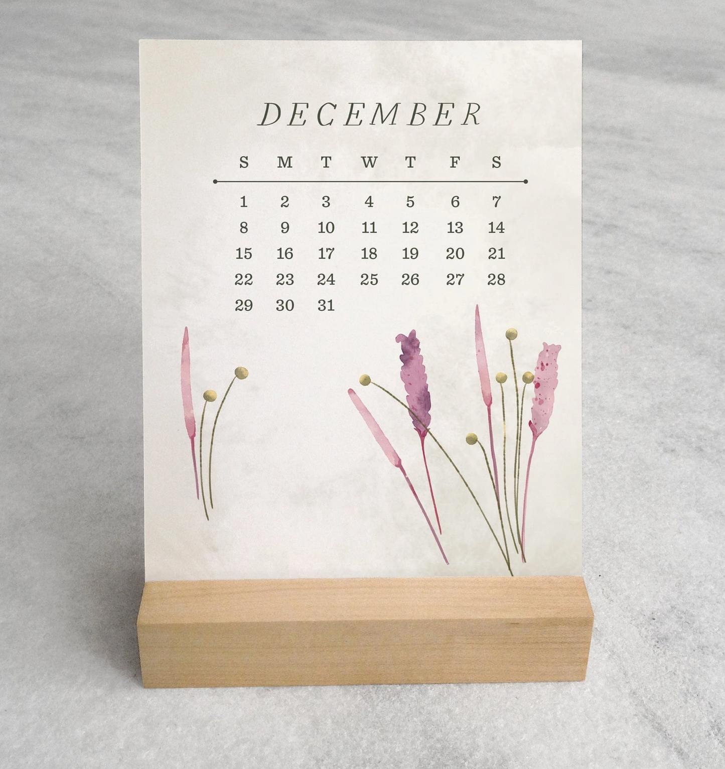 The 2025 Desk Calendar from Me To You Box, featuring 4.25" x 5.5" cards with unique monthly designs and a durable maple wood stand. This compact calendar fits perfectly on any desk, offering daily inspiration and organization with a touch of aesthetic charm.