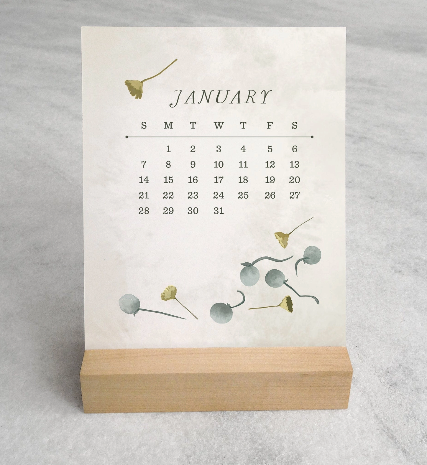 The 2025 Desk Calendar from Me To You Box, featuring 4.25" x 5.5" cards with unique monthly designs and a durable maple wood stand. This compact calendar fits perfectly on any desk, offering daily inspiration and organization with a touch of aesthetic charm.