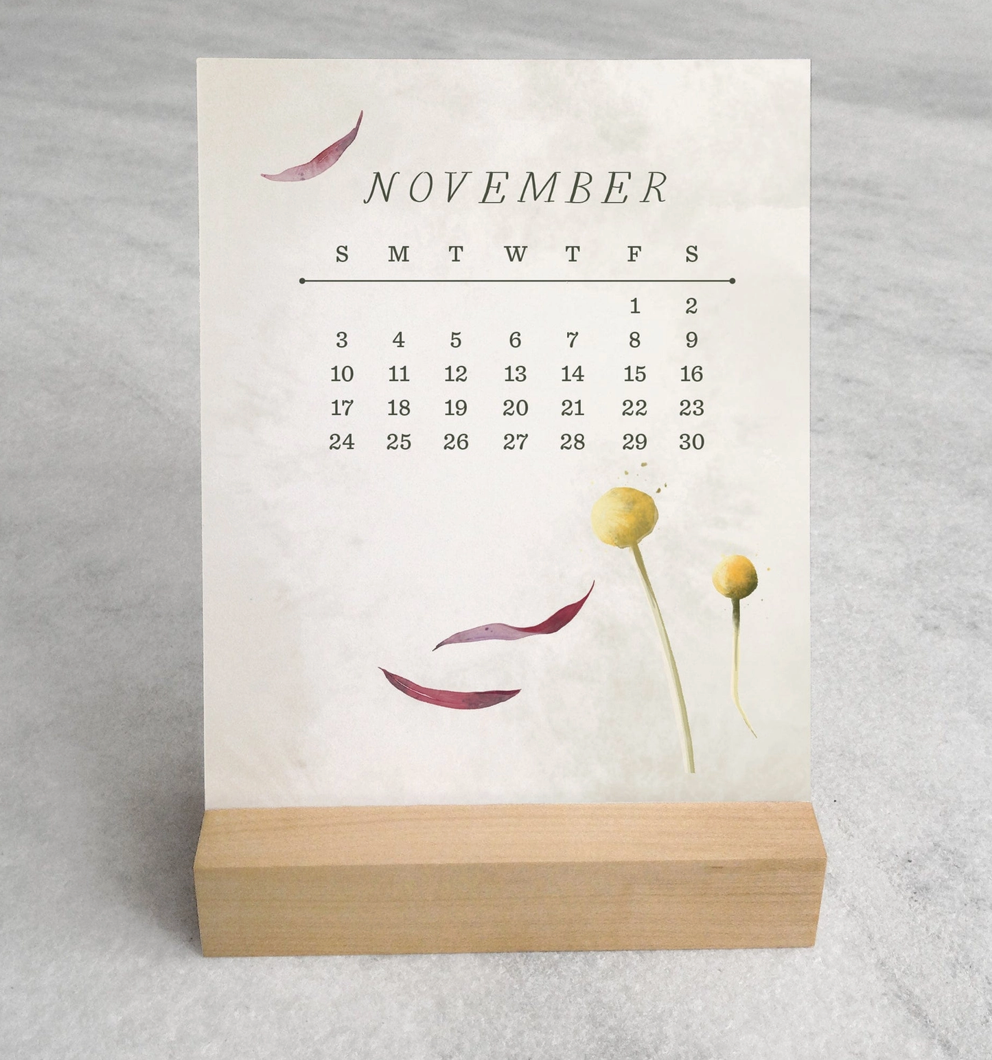 The 2025 Desk Calendar from Me To You Box, featuring 4.25" x 5.5" cards with unique monthly designs and a durable maple wood stand. This compact calendar fits perfectly on any desk, offering daily inspiration and organization with a touch of aesthetic charm.