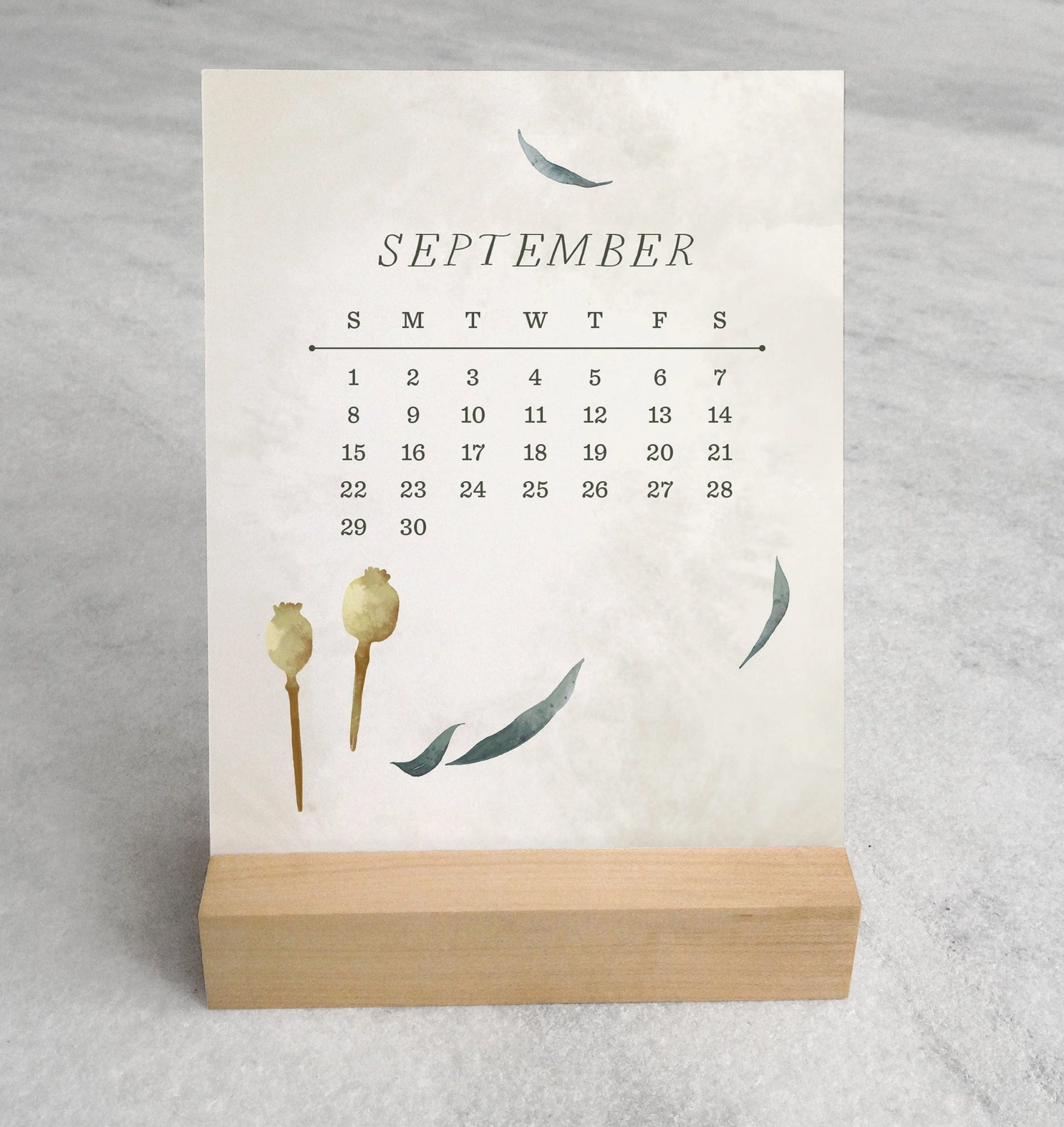 The 2025 Desk Calendar from Me To You Box, featuring 4.25" x 5.5" cards with unique monthly designs and a durable maple wood stand. This compact calendar fits perfectly on any desk, offering daily inspiration and organization with a touch of aesthetic charm.