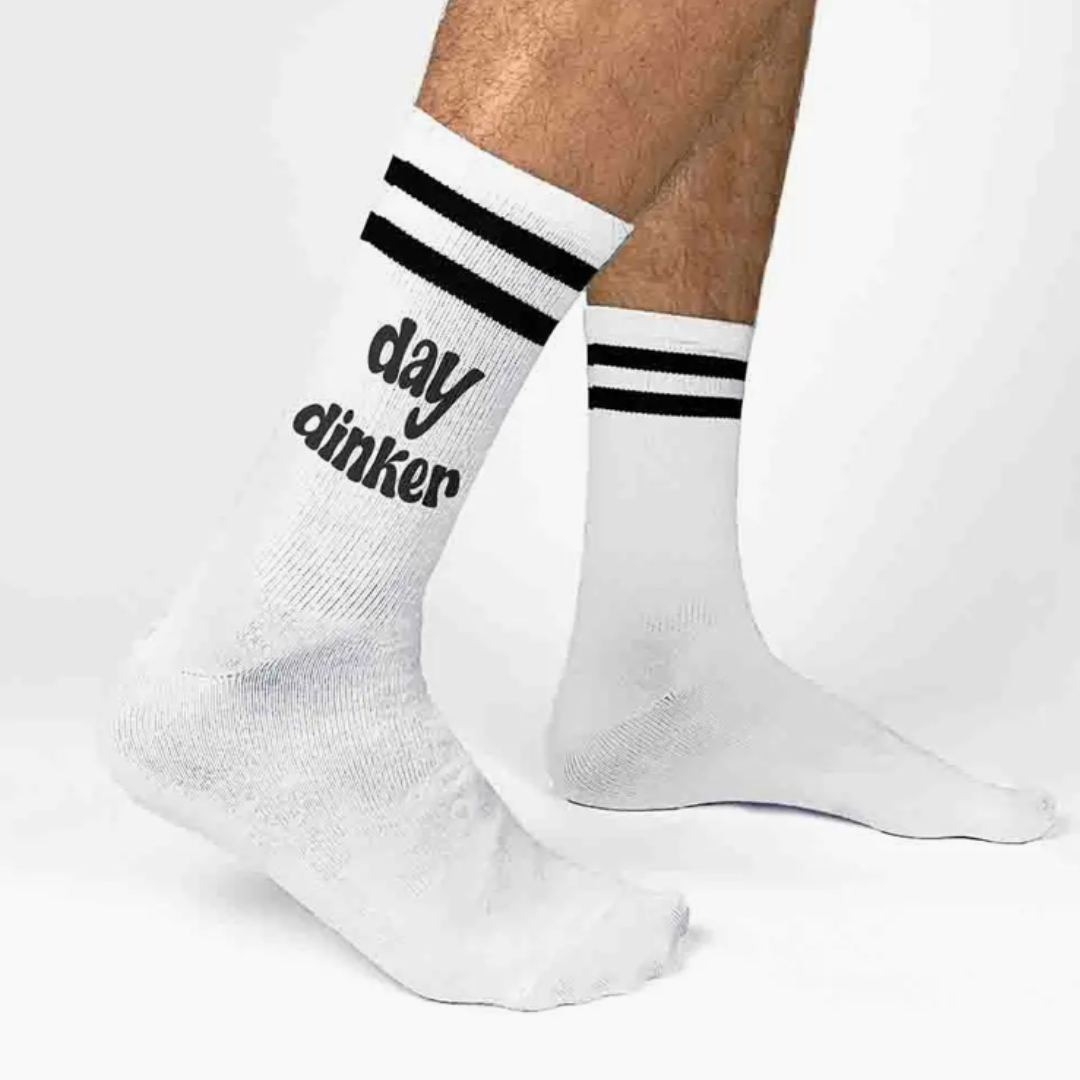 Women's crew pickleball socks displaying the playful phrase 'Day Dinker', adding personality to your pickleball outfit.