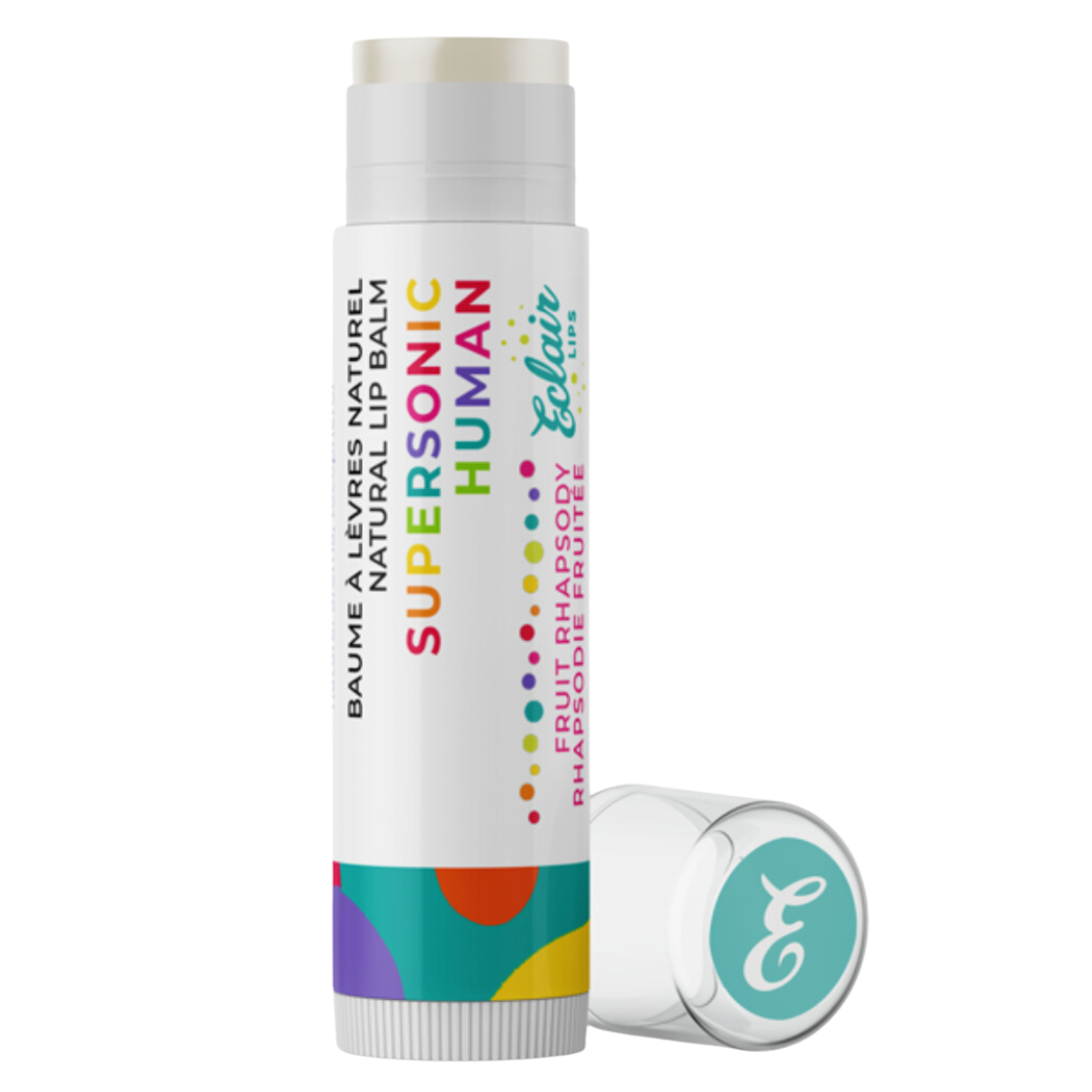 A close-up of a Super Sonic Human lip balm, showcasing its vibrant packaging with bold colors and sleek design. The logo prominently displayed against a backdrop of energetic patterns, conveying a sense of dynamism and style.