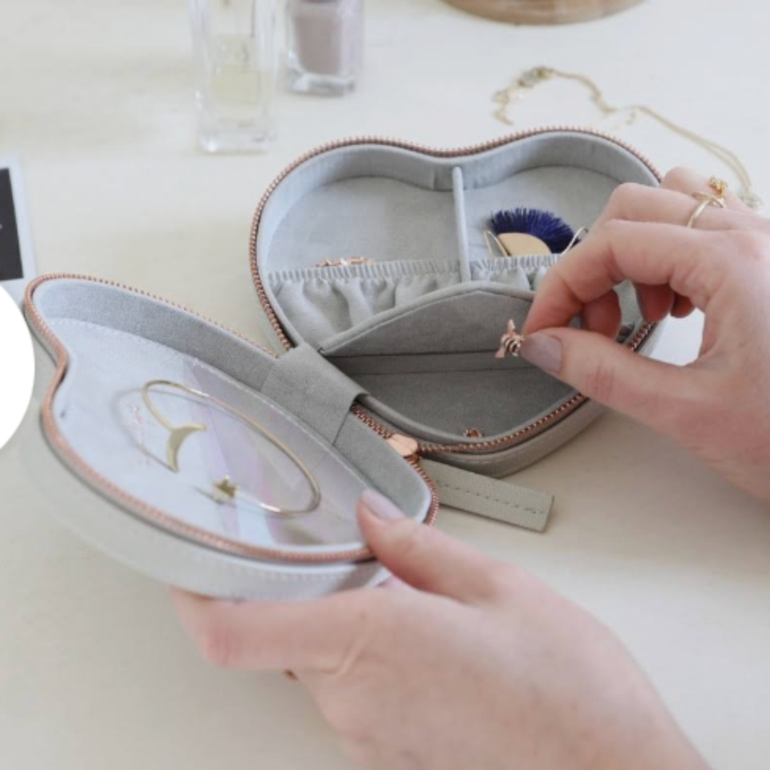 Compact travel-friendly grey heart jewelry organizer with convenient zip-around design.