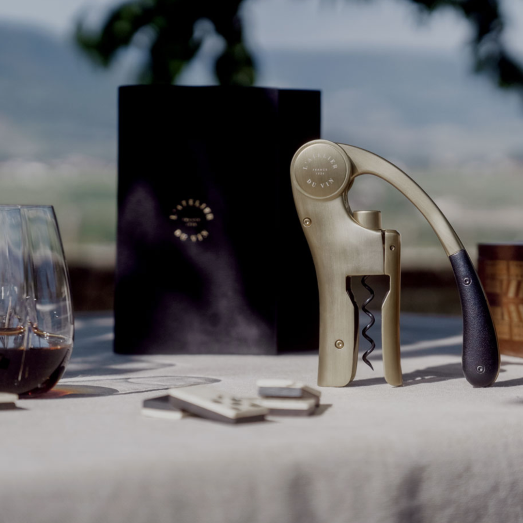 L'Atelier du Vin wine opener resting on vineyard picnic table.