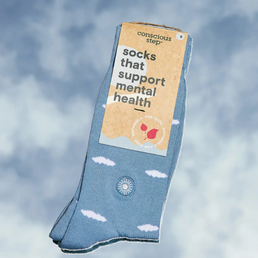 Soft blue socks with clouds, advocating mental health awareness.