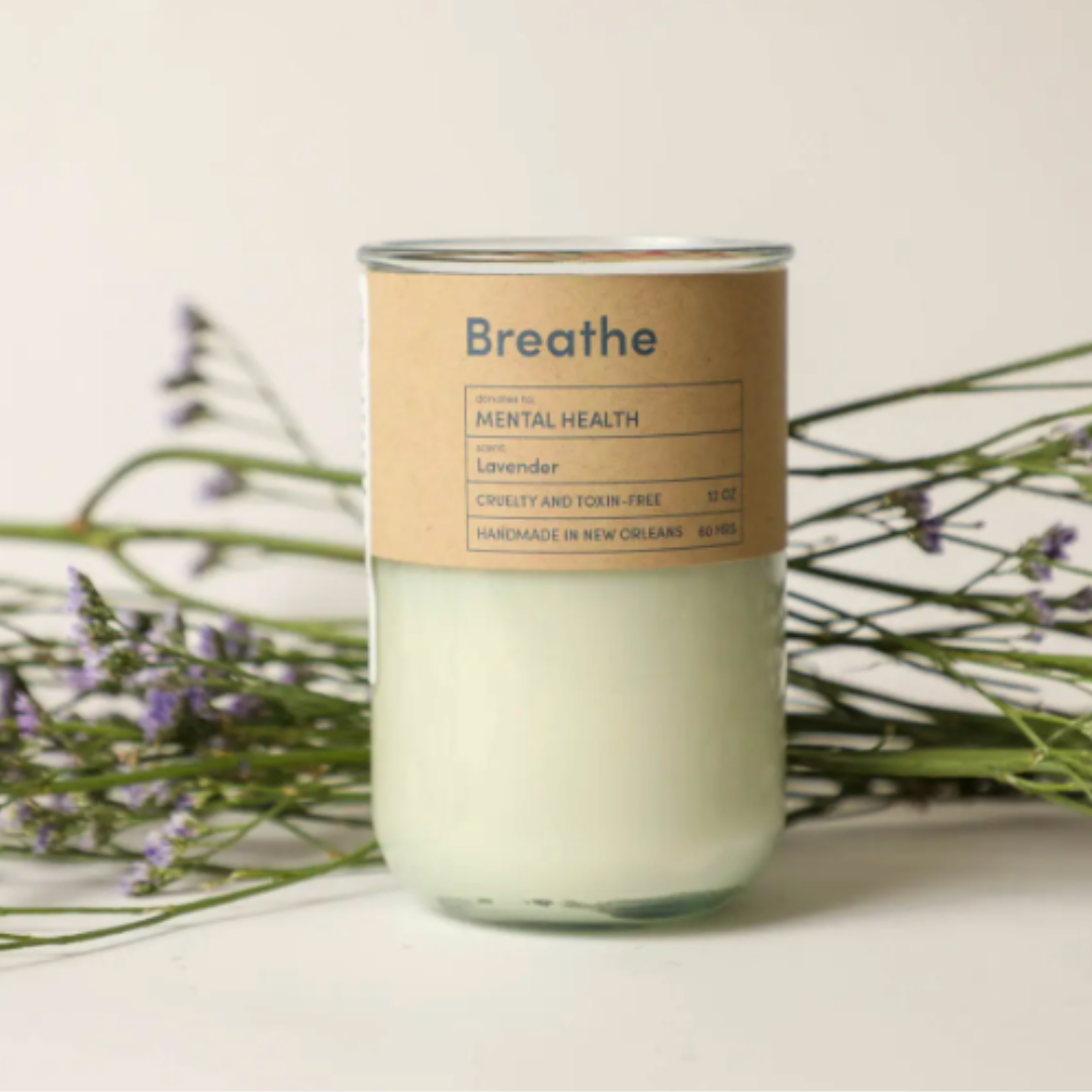 Glass jar candle with calming lavender scent for mental health.
