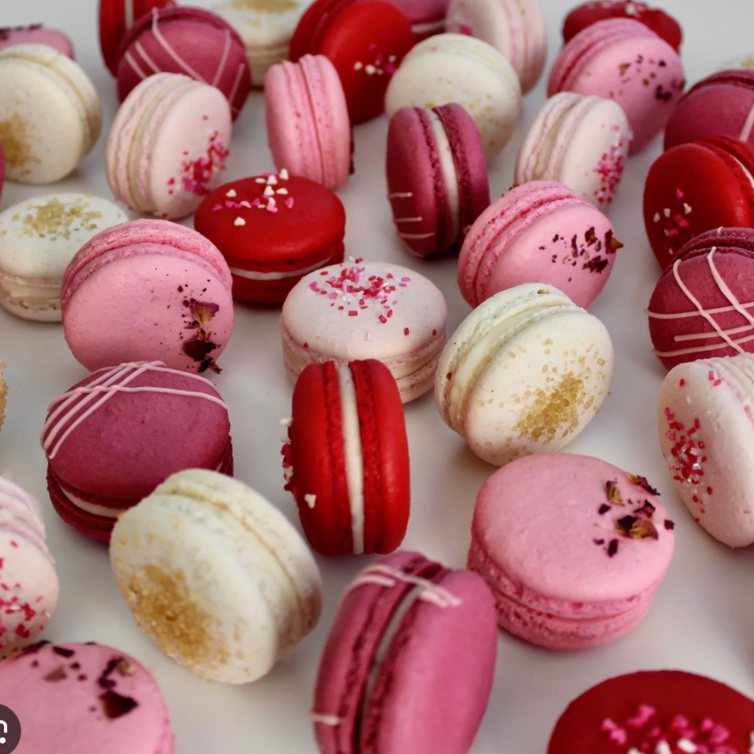 Colorful duo of macarons: cherry amaretto and strawberries & champagne.