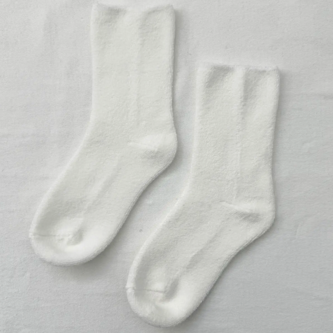 Soft white socks for women, providing warmth and comfort with a cozy, stylish touch.