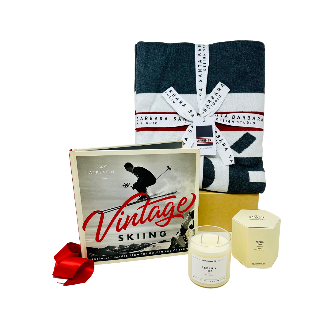 Me To You Box APRÉS SKI gift set, featuring a cozy cotton throw blanket, a vintage skiing photography book, and an Aspen & Fog soy candle with mountain-inspired scents. Thoughtfully curated for warmth and elegance, each purchase supports Julia's Butterfly Foundation and Little Angels Care Package Program. Perfect for ski lodge ambiance or as a sophisticated holiday gift.