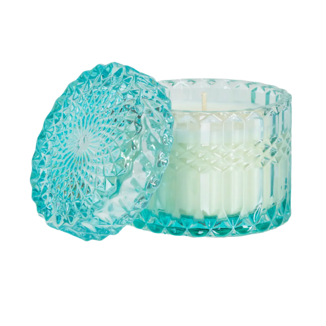 Aqua de Soi candle in blue shimmering glass vessel.