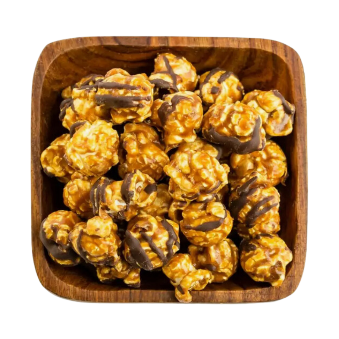 Artisan Caramel Chocolate Popcorn: A 6.4 oz bag of popcorn enveloped in caramel and drizzled with chocolate, finished with Mediterranean sea salt. Ethically sourced and handcrafted in NY, this dairy-free, vegan snack was highlighted in Oprah’s Favorite Things. Gluten-free and nut-free, it's sealed for optimal freshness and perfect for gifting.