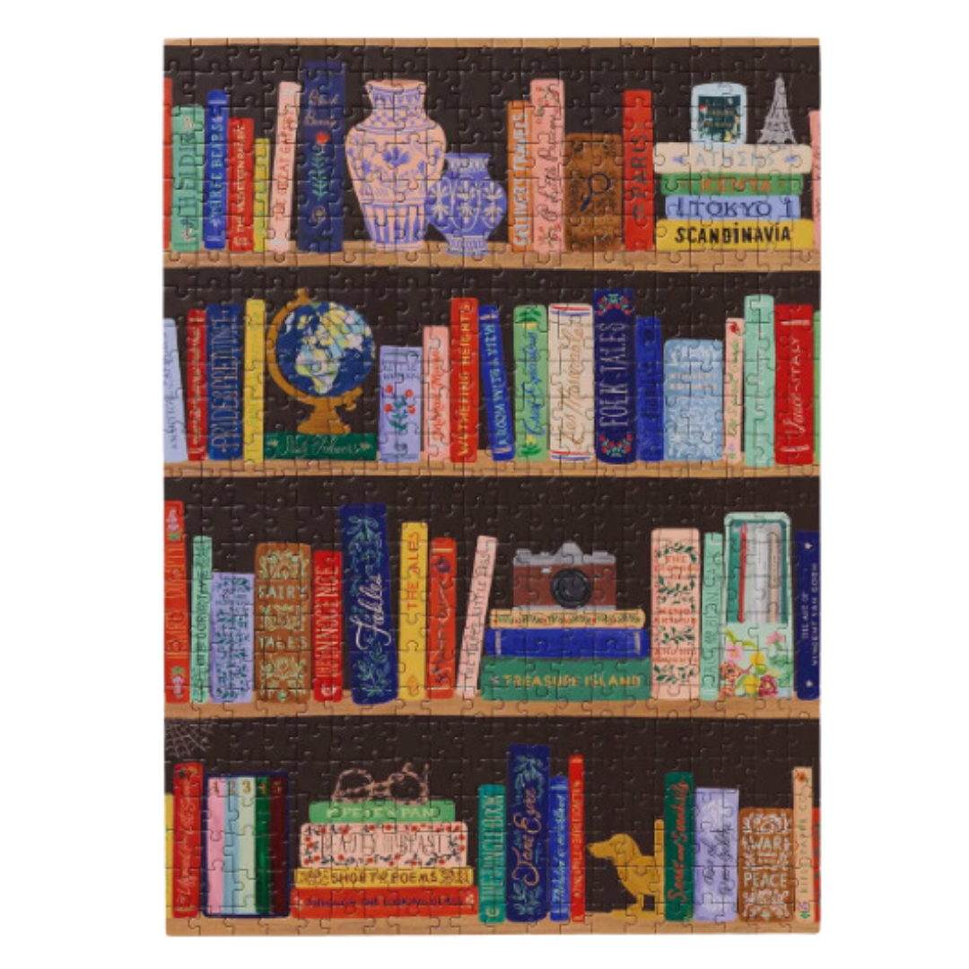 Artistic bookshelf puzzle from Rifle Paper Co., with intricate design and premium quality construction, perfect for gifting or a creative pastime.