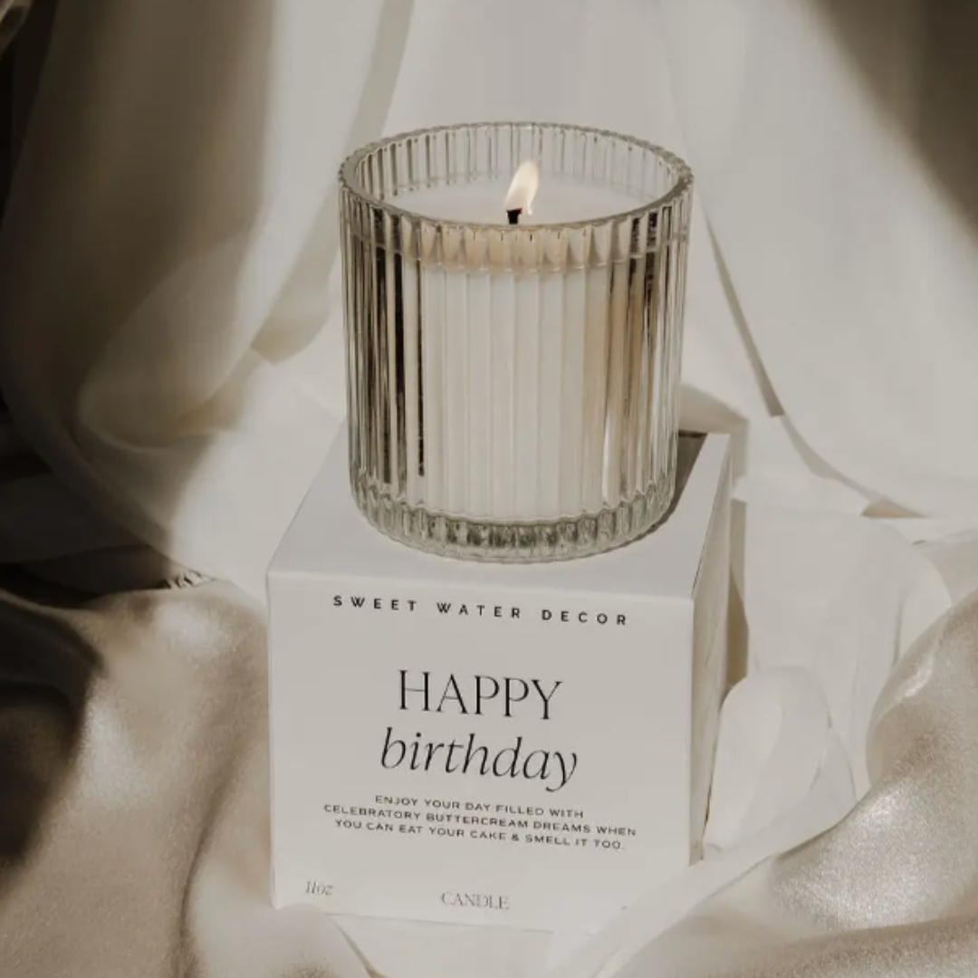 Scented Happy Birthday candle with Tahitian Vanilla, Powdered Sugar, and Buttercream fragrance, housed in a festive gift box.