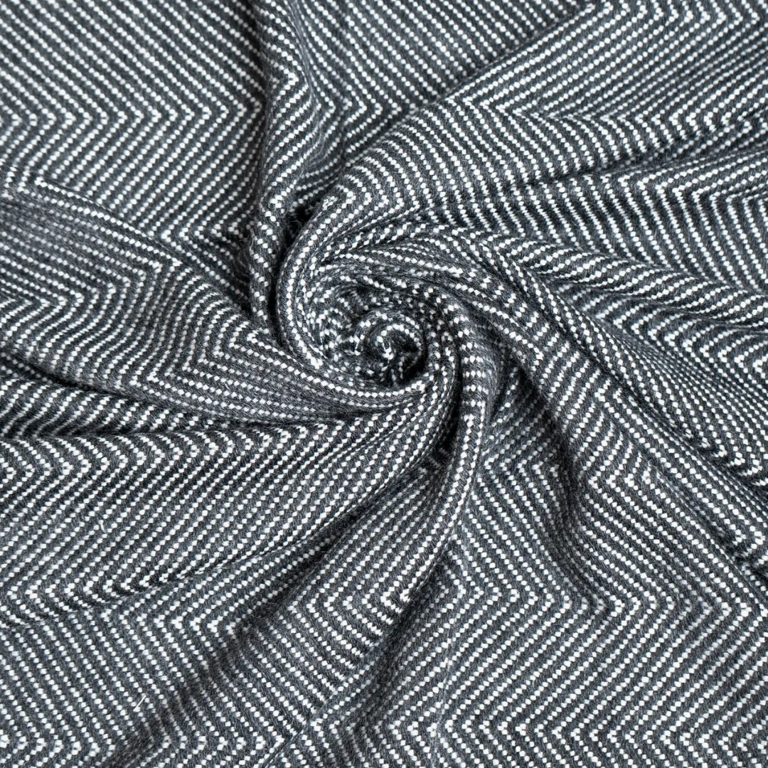 Close-up of cashmere fabric with a zigzag pattern in black and white.