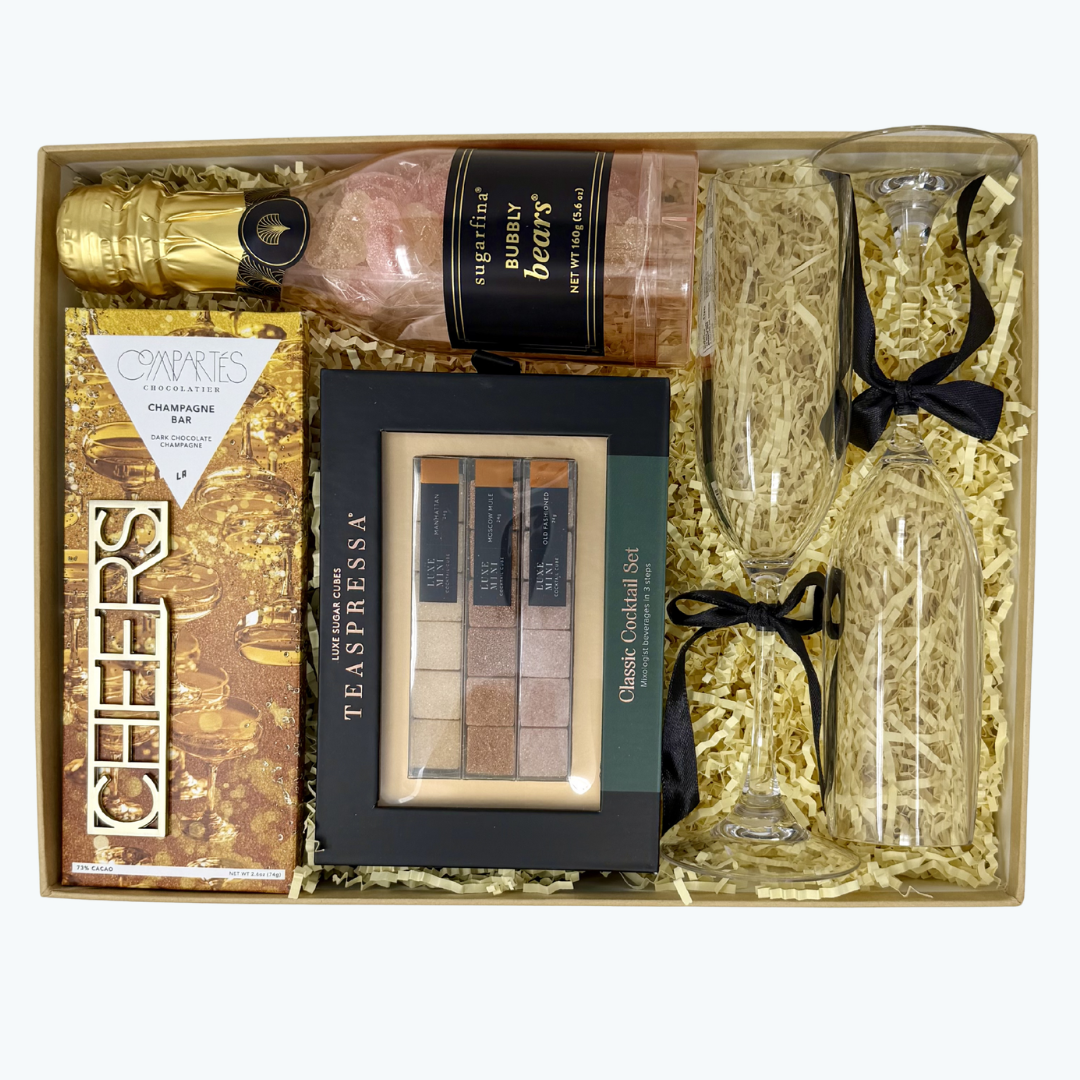 Gift set with classic cocktail kit, champagne flutes, chocolate bar and gummy bears  in a box.