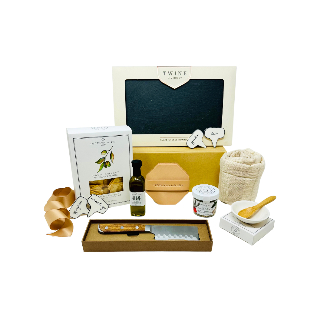 Gourmet Cheese Please Charcuterie Board Gift Box featuring a slate board, olive oil, dipping spices, crackers, cheese markers, leather coasters, and a cheese knife, designed for elegant and enjoyable entertaining.