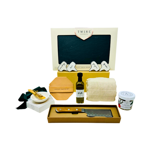 Gourmet Cheese Please Charcuterie Board Gift Box featuring a slate board, olive oil, dipping spices, four ceramic cheese markers, leather coaster set, and a cheese knife, designed for elegant and enjoyable entertaining.