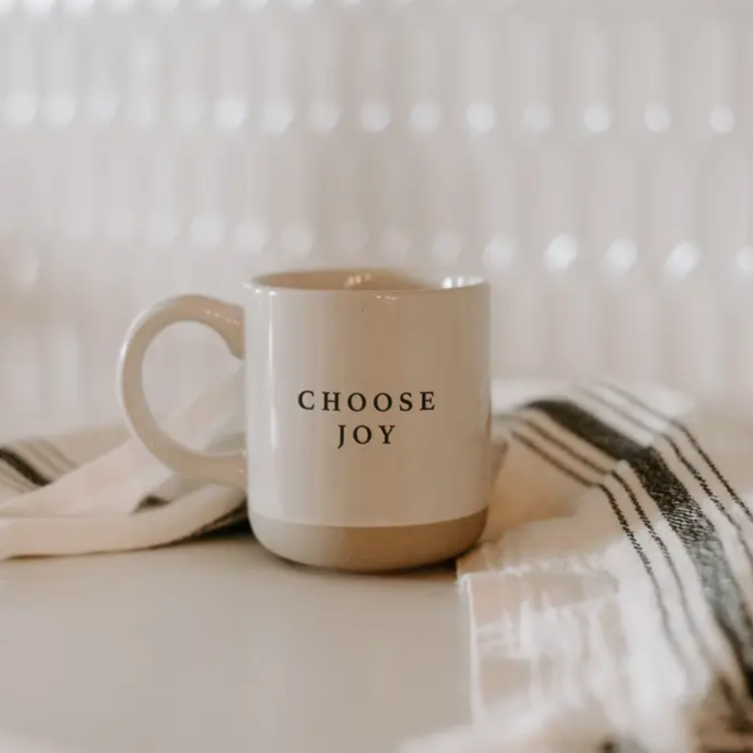 The "Choose Joy" stoneware mug, showcasing its sturdy, classic shape with a motivational quote printed on the front, perfect for adding a touch of positivity to your daily routine.