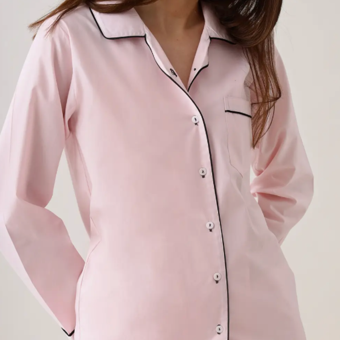 Classy Pink pajama set from Little West Street displayed in a matching fabric gift bag. The set includes a soft, full-sleeve top with a notched collar and pajamas with a comfortable elastic waistband and contrast cording, emphasizing both luxury and practicality.