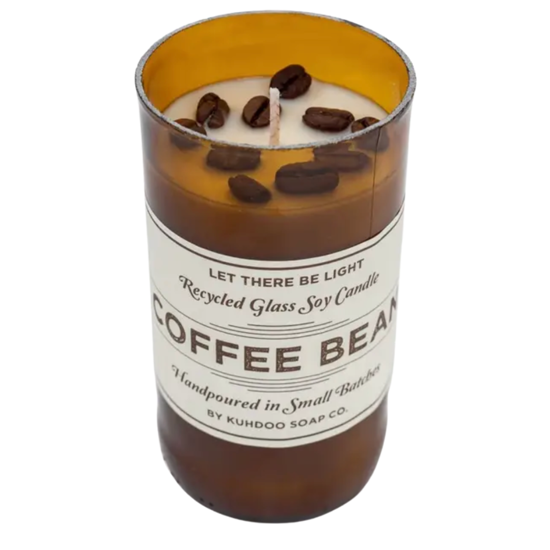 A coffee-scented candle in a glass jar, adorned with real coffee beans sprinkled on top, creating a rustic and aromatic display.