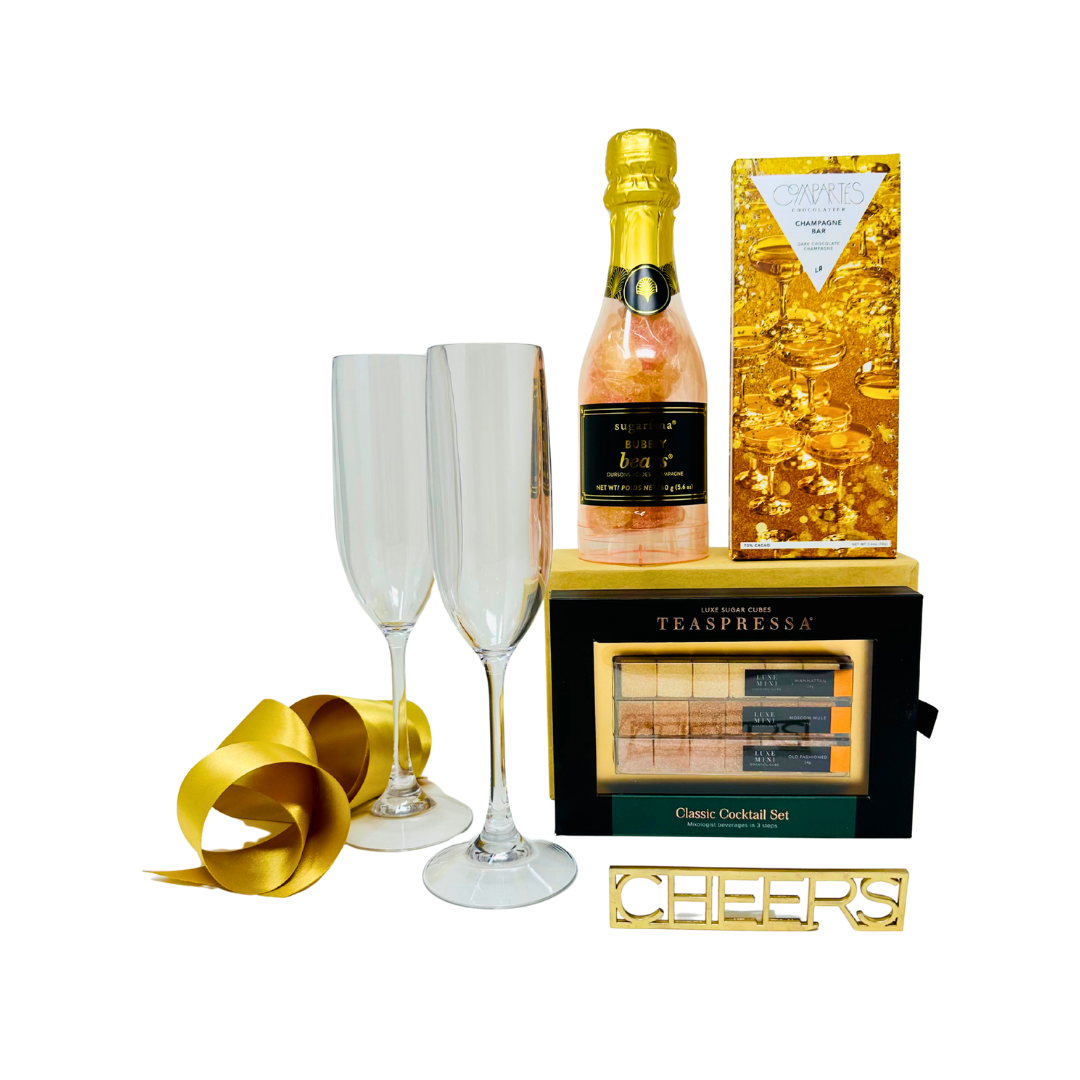 Gift set with champagne, glasses, and cocktail set on a white background.
