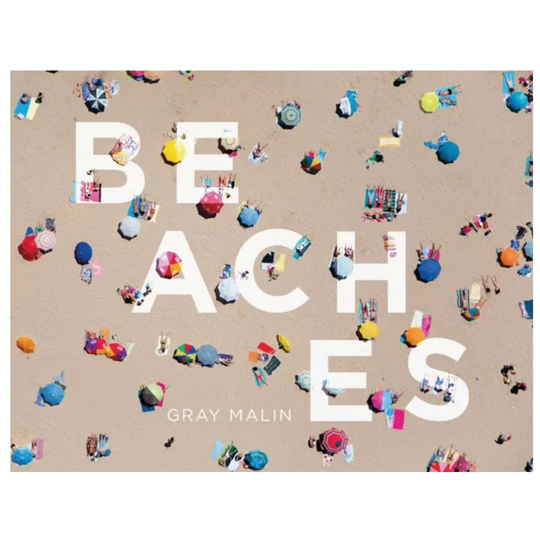 Cover of Beaches the book showing a beach. The photo is taken with a camera from a helicopter over the beach. The beach is filled with people lounging with vibrant colored beach towels and beach umbrellas.