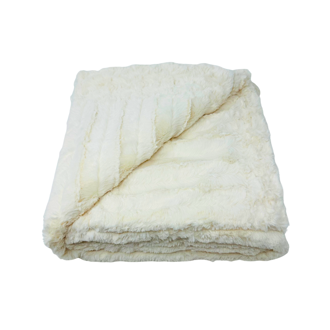 Cozy cream blanket folded up and shown on a white background.