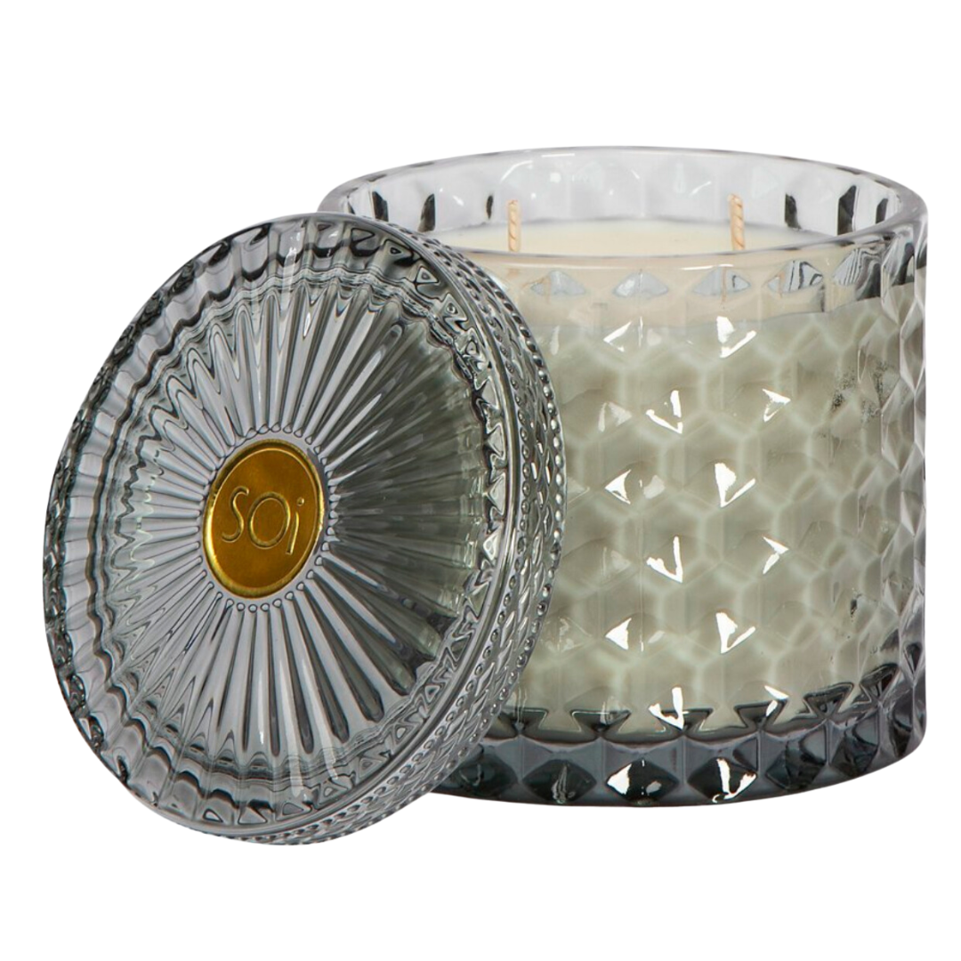 Aqua de Soi's Heathered Suede Shimmer Candle is a 15oz double wick soy wax candle in a beautiful grey cut glass vessel. The diamond-cut glass makes this candle a luxurious addition to any space. Filled with 100% all natural, food-grade kosher soy oil, that burns cleaner and up to 40% longer than paraffin, wax or traditional soy blend candles. Heathered Suede Glass Shimmer Candle has scents of Brushed Suede, Oakmoss Embers & Palo Santo. Approximately a 55 hour burn time.